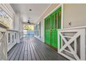 Spacious covered front porch featuring a vibrant green double door entrance at 2508 W Shell Point Rd, Tampa, FL 33611