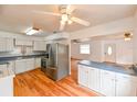 Bright kitchen with stainless steel appliances, white cabinetry, and wood flooring, creating a modern and functional space at 3302 W Van Buren Dr, Tampa, FL 33611