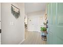 Bright entryway featuring a stylish welcome sign, tile floors, and neutral walls at 6980 Ulmerton Rd # 8C, Largo, FL 33771