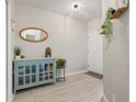 Charming entryway with wood-look floors and a decorative cabinet display at 6980 Ulmerton Rd # 8C, Largo, FL 33771