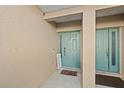 Inviting front entrance with a colorful welcome mat and refreshing blue door at 6980 Ulmerton Rd # 8C, Largo, FL 33771