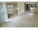 Open-concept living room featuring tile flooring, and natural light at 8503 N Willow Ave, Tampa, FL 33604