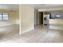 Spacious living area featuring tile flooring, and stainless steel appliances in the kitchen at 8503 N Willow Ave, Tampa, FL 33604
