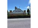 Del Webb Southshore Falls entrance sign framed by vibrant greenery and a neatly paved road at 116 Silver Falls Dr, Apollo Beach, FL 33572