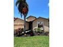 Beautiful single-story home featuring a well-manicured lawn and vibrant, tropical landscaping at 116 Silver Falls Dr, Apollo Beach, FL 33572