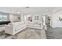 Open living room with large sectional sofa, stylish rug, and modern decor at 1514 Sea Gull S Dr, St Petersburg, FL 33707