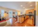 Open concept living featuring hardwood floors and a dining and kitchen combo at 3410 Sondrio Cir, Tampa, FL 33611