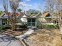 Unique home featuring peaked roofs, symmetrical design and a gated front entrance in a tropical landscape at 4811 Paradise S Way, St Petersburg, FL 33705