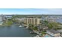 Scenic aerial view showcasing waterfront property with a multi-story building and picturesque city skyline in the distance at 5701 Mariner St # 606, Tampa, FL 33609