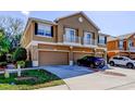 Townhouse featuring a three-car garage, complemented by a neutral color scheme and second story balconies at 7510 Red Mill Cir, New Port Richey, FL 34653