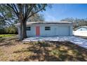Well-kept one-story home featuring a light blue paint and a vibrant pink front door at 2709 57Th S St, Gulfport, FL 33707
