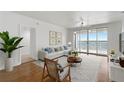 Bright living room featuring modern decor, stylish furnishings, and sliding glass doors with a beautiful waterfront view at 4993 Bacopa S Ln # 304, St Petersburg, FL 33715