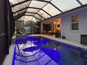 Stunning screened-in pool with lighting and a lounge area providing a relaxing outdoor experience at 817 Wilkie St, Dunedin, FL 34698