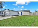 Attractive one-story home with a well-maintained lawn, fenced in yard, and brick accents at 912 Lochmont Dr, Brandon, FL 33511