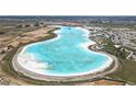Aerial view of the community's massive aqua-blue lagoon and beach club with construction in progress at 10944 Delta Huff Ct, San Antonio, FL 33576