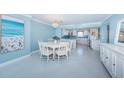 Open-concept dining area with chandelier lighting and a modern beach themed decor at 5130 Brittany S Dr # 201, St Petersburg, FL 33715