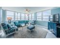 This cozy living room features water views and coastal-themed furniture with a ceiling fan at 5130 Brittany S Dr # 201, St Petersburg, FL 33715