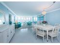 Bright living room with water views, modern furniture, and tile floors at 5130 Brittany S Dr # 201, St Petersburg, FL 33715