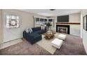 Cozy living room with a fireplace, a large window, and comfortable seating area at 1213 60Th S St, Gulfport, FL 33707