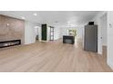 Bright and airy living space with wood floors, a modern fireplace, and sliding door access to the backyard at 1520 Arnold Ave, Brooksville, FL 34601