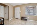 Bright entryway features tile floors, shoe rack, and access to other rooms at 2713 W Osborne Ave, Tampa, FL 33614