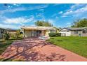 Quaint single-story home with a well-manicured lawn and a convenient carport, perfect for easy access at 2713 W Osborne Ave, Tampa, FL 33614