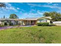 Charming one-story home with a well-maintained lawn and mature landscaping at 2713 W Osborne Ave, Tampa, FL 33614