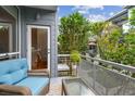 Relaxing balcony featuring a cozy seating area with a stylish glass-top table, perfect for enjoying outdoor living at 337 4Th S Ave, St Petersburg, FL 33701
