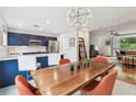 Open-concept kitchen and dining area with navy cabinets, stainless steel appliances, and modern lighting at 337 4Th S Ave, St Petersburg, FL 33701