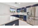 Modern kitchen featuring stainless steel appliances, blue cabinets and bright white countertops at 337 4Th S Ave, St Petersburg, FL 33701