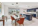 Modern kitchen with dark cabinets, white countertops, a large window, and a dining area that is ideal for gatherings at 337 4Th S Ave, St Petersburg, FL 33701