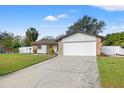 Home exterior with a lush green lawn and a two car garage at 5834 71St N St, St Petersburg, FL 33709