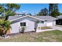 Well-maintained single-story home with an attached garage, manicured front yard, and fresh exterior paint at 620 43Rd Street W Blvd, Palmetto, FL 34221