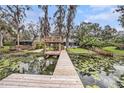 Backyard dock over water feature of home for relaxing by the water at 8922 Donna Lu Dr, Odessa, FL 33556