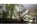 Exterior shot of the condo complex's stairs near mature landscaping at 11723 Raintree Village Blvd # B, Temple Terrace, FL 33617