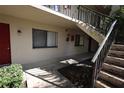 Exterior view of the condo building featuring access stairs and a well-maintained entrance at 11723 Raintree Village Blvd # B, Temple Terrace, FL 33617