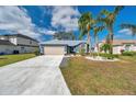 Lovely single Gathering home with beautiful landscaping, green lawn, and a two car garage at 1204 50Th E St, Bradenton, FL 34208