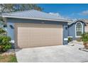 Attached two-car garage in a blue single Gathering home, spacious parking and convenient access at 1204 50Th E St, Bradenton, FL 34208
