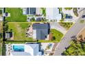 Aerial shot displaying the home's roof, well-kept lawn, and neighboring properties, with a defined property line at 2016 Culberson Ave, Dunedin, FL 34698