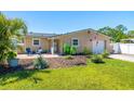 A well-kept front yard with lush lawn and landscaping, complemented by a charming home with a single-car garage at 2016 Culberson Ave, Dunedin, FL 34698