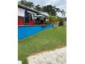 Outdoor entertaining space with ample seating around a brightly painted raised patio at 2102 W Ivy St, Tampa, FL 33607