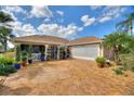 Beautiful single-story home with a brick driveway, well-manicured landscaping, and an attached two-car garage at 2359 Emerald Lake Dr, Sun City Center, FL 33573