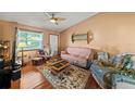Inviting living room featuring hardwood floors, a large window, and comfortable furnishings at 2940 Bay View Dr, Safety Harbor, FL 34695
