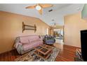 A cozy living room with hardwood floors, ceiling fan, and comfortable seating arrangement at 2940 Bay View Dr, Safety Harbor, FL 34695