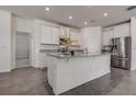 Bright kitchen with an island, stainless steel appliances, and granite countertops at 3624 Autumn Amber Dr, Spring Hill, FL 34609