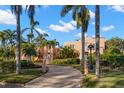 Grand estate with gated entry, circular driveway, mature palm trees, and lush landscaping at 6935 Date Palm S Ave, St Petersburg, FL 33707