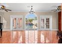 Bright living room with french doors overlooking the pool area providing seamless indoor/outdoor living at 6935 Date Palm S Ave, St Petersburg, FL 33707
