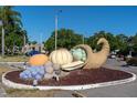 View of a community cornucopia decoration with colorful oversized fruits and vegetables at 8199 Terrace Garden N Dr # 212, St Petersburg, FL 33709