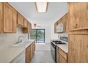 Kitchen with light wood cabinets, white countertops and a view to the lanai at 8199 Terrace Garden N Dr # 212, St Petersburg, FL 33709