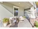 Inviting covered front porch featuring stylish seating and elegant decor at 13218 Satin Lily Dr, Riverview, FL 33579